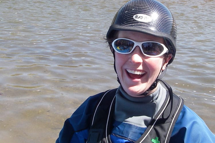 A happy female whitewater kayaker